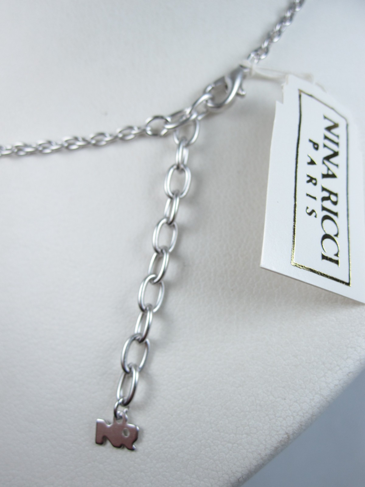 Nina Ricci Rhodium Plated Pendant with Swarovski Crystals – 16-18″ length 9380