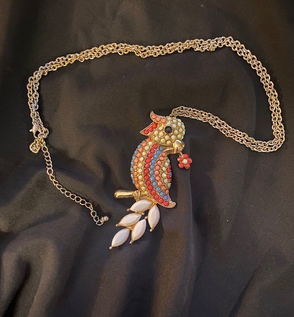 Gold-tone, multi-colored enamel and rhinestone parrot pendant necklace.