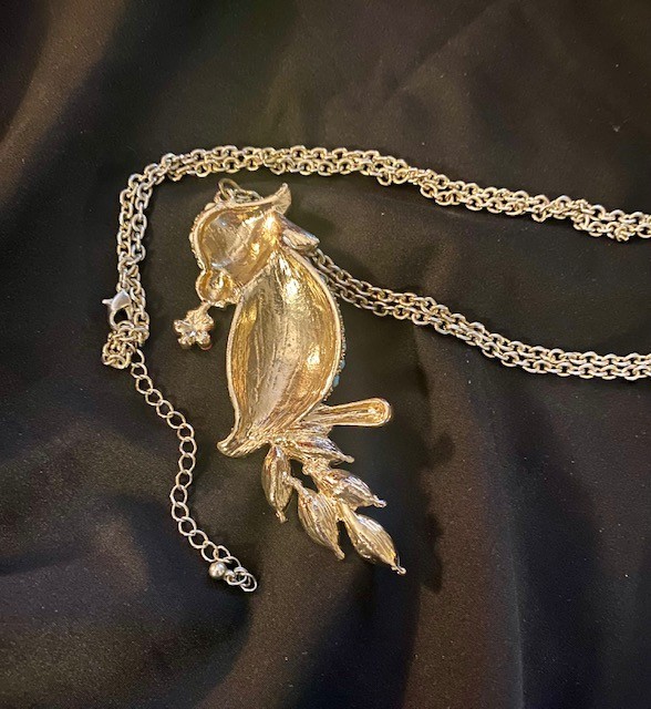 Gold-tone, multi-colored enamel and rhinestone parrot pendant necklace.