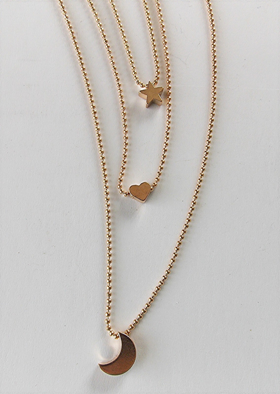 MULTI-LAYER GOLDTONE ADJ. 3 STRAND STAR, HEART, & CRESCENT MOON PENDANT NECKLACE