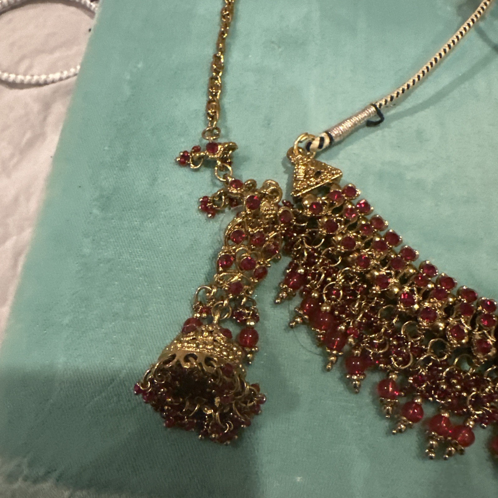 Fashion Jewelry Maroon Necklace With Jhumkas With Hair Attachment In Gold Tone